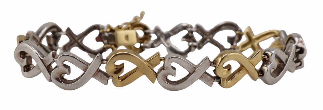 JEWELRY. Paloma Picasso for T&Co. 18kt Gold and: Sterling Bracelet. Paloma Picasso for Tiffany & Co. "Loving Heart" sterling and 18kt yellow gold heart pendant bracelet. Stamped, "T&Co. ©Paloma Picasso 925" to one st