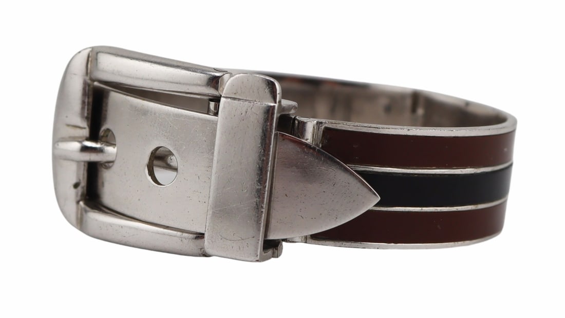 JEWELRY. Gucci Brown and Black Enamel Bracelet.: Gucci silver-tone buckle form bracelet displaying brown and black enamel decorated stripes. Stamped, "Gucci Italy" with a "S" within a lozenge form frame. From a Nyack, NY estate. 