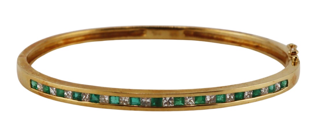JEWELRY. 18kt Gold, Emerald and Diamond Bracelet.: 18kt yellow gold hinged bracelet displaying alternating square faceted emerald and diamonds. Stamped, "750 18K" to the interior of the band. Accompanied by a 9/9/97 Durant Jewelers receipt i