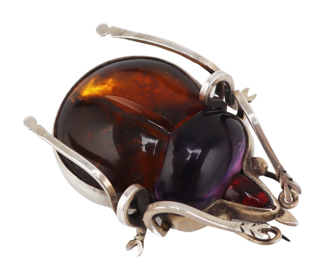 JEWELRY. Silver and CHUNKY Colored Gem Bug Brooch: Vintage silver bug form brooch displaying a carved and polished amber body, a carved and polished amethyst pendant, and an elongated polished garnet? cabochon. Apparently unmarked. Total approx. weigh