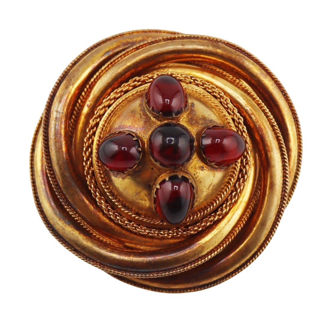 JEWELRY. Victorian Gold and Garnet Cabochon Brooch: Victorian 15kt gold and garnet cabochon lover's knot brooch with locket verso. The piece has been gilt with a higher karat gold finish and fitted with a brass pinback. Applied plaque stamped, "15