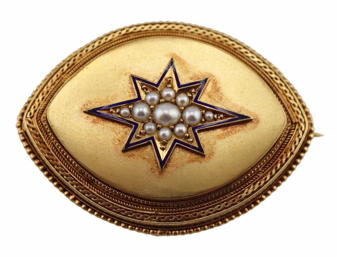 JEWELRY. Victorian 9kt Gold, Enamel and Pearl: Brooch of Pendant. Victorian 9kt gold lozenge or "eye" form brooch displaying a central blue enamel outlined star pendant accented throughout the interior by multiple sizes of pearls. The br