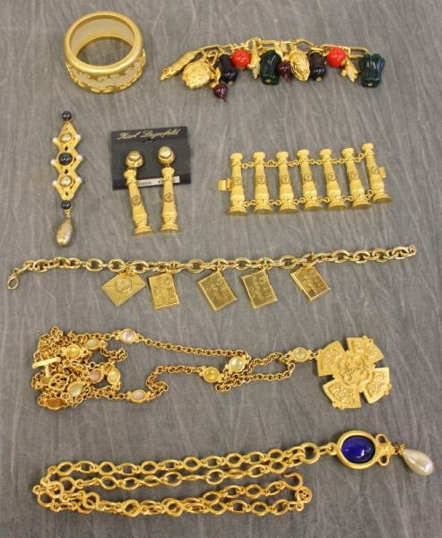 JEWELRY. Lot of Karl Lagerfeld.: Includes a bangle, fruit bracelet, medallion necklace, a torch bracelet and torch earrings, etc. 8 pieces total. From a Yonkers, NY location.
