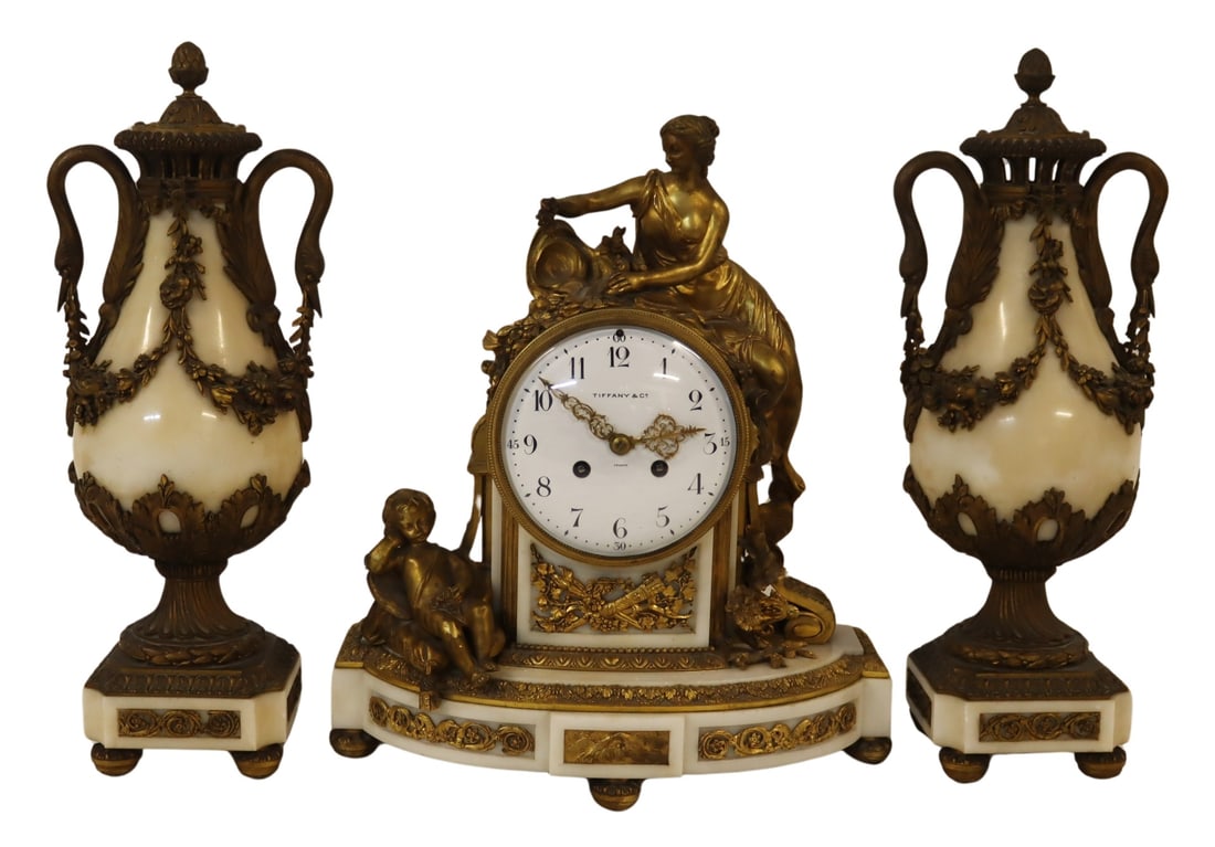 TIFFANY Fine & Large Bronze Mounted Marble Clock: Garniture Set. The French marble clock (17"h x 14"w) bronze with gilt bronze mounts and the face enamel signed Tiffany. The movement with French marks. From a Rye, NY estate. - Dimensions: 1