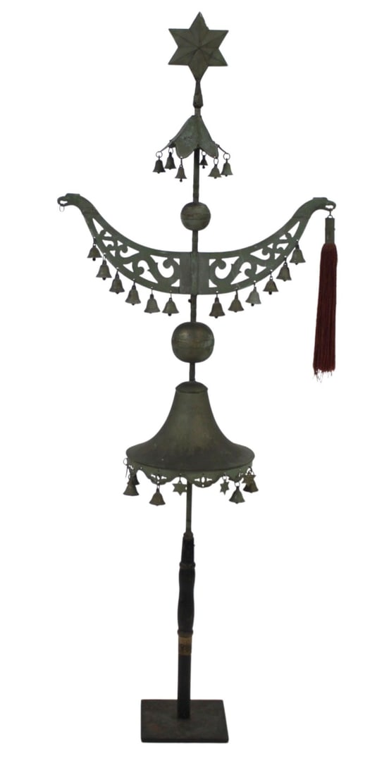 Antique Schellenbaum with Stand.: Tall military percussion instrument with multiple bells and stars with one red tassel. Decorative bird carvings hold the tassels with the beak. Bells & stars vary in size. From a Bloomfield, NJ es