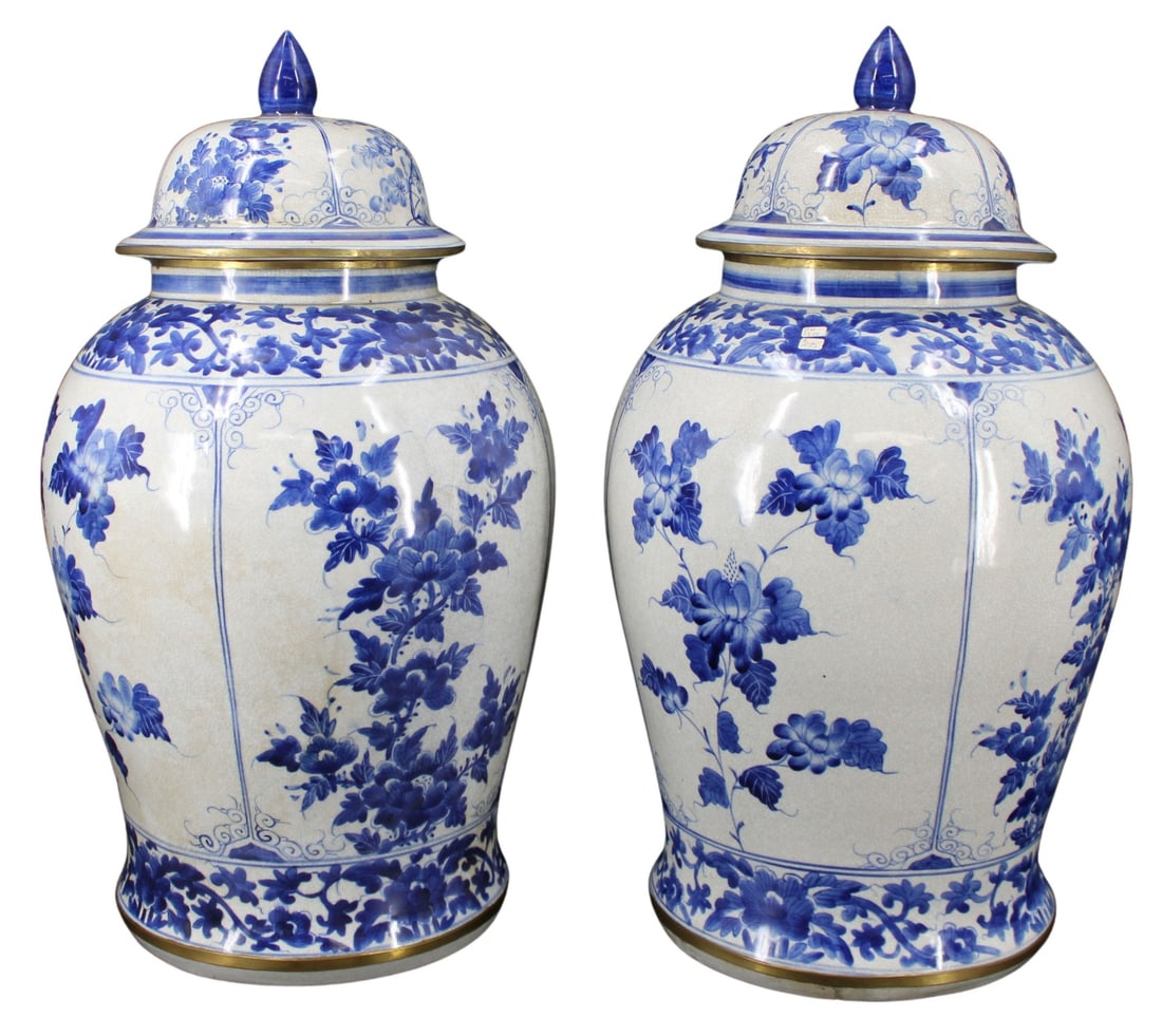 Collection of Chinese Inspired B&W Porcelain.: Pair of Chinese inspired blue and white lidded urns. (2) urns, each finished in a faux-crackle glaze decorated in blue and white flowers of various species and sizes. The bottom rim of the lid and bod
