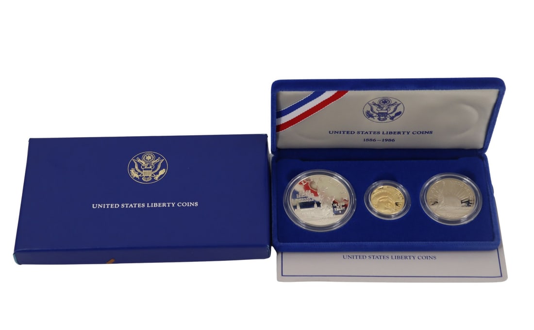 NUMISMATICS 1986 3-Coin Commem Statue of Liberty: Proof Set. Including (1) 1986 W $5 Proof Statue Of Liberty Commemorative gold coin, struck in .900 fine gold. The total mintage for this date & mint: 404,013. (1) 1986 S $1 Proof Statue Of Liberty