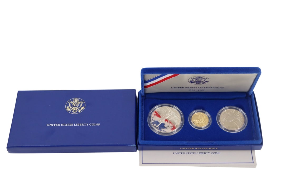 NUMISMATICS 1986 3-Coin Commem Statue of Liberty: Proof Set. Including (1) 1986 W $5 Proof Statue Of Liberty Commemorative gold coin, struck in .900 fine gold. The total mintage for this date & mint: 404,013. (1) 1986 S $1 Proof Statue Of Liberty