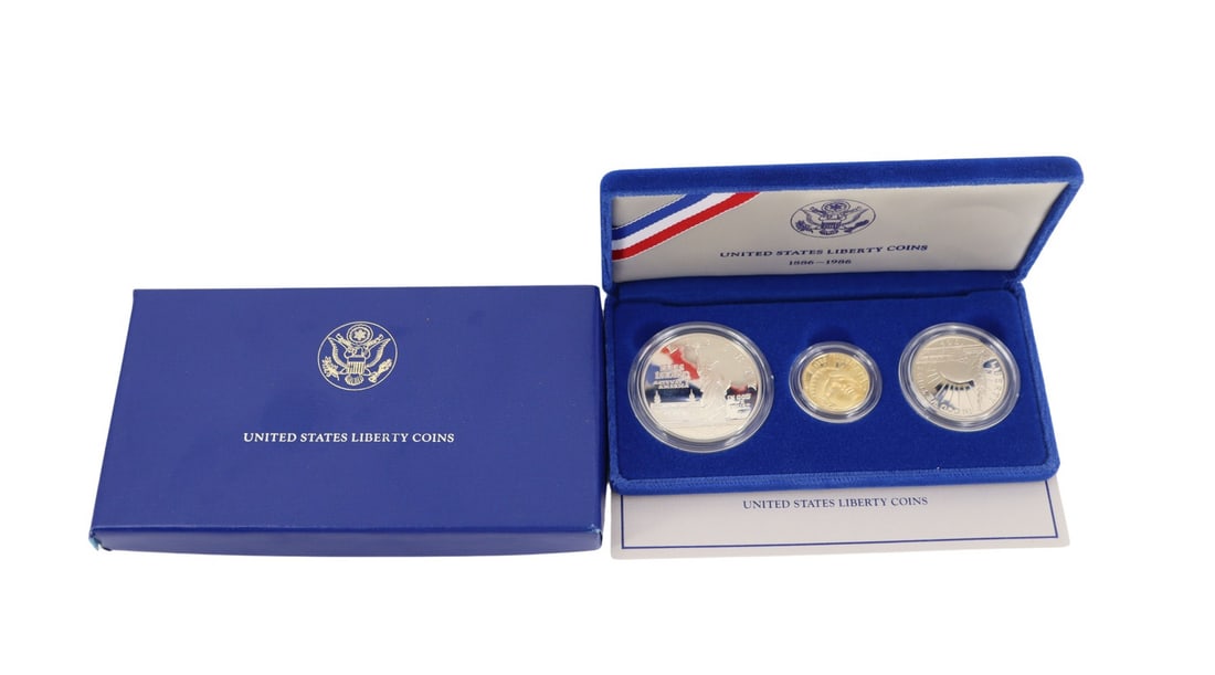 NUMISMATICS 1986 3-Coin Commem Statue of Liberty: Proof Set. Including (1) 1986 W $5 Proof Statue Of Liberty Commemorative gold coin, struck in .900 fine gold. The total mintage for this date & mint: 404,013. (1) 1986 S $1 Proof Statue Of Liberty