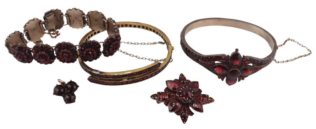 JEWELRY. Collection of Antique Garnet Jewelry.: Includes a hinged garnet bracelet with central floret form pendant; a bypass style garnet inlaid hinged bracelet - with a single missing garnet, and a repair; a foliate or star form garnet inlaid broo