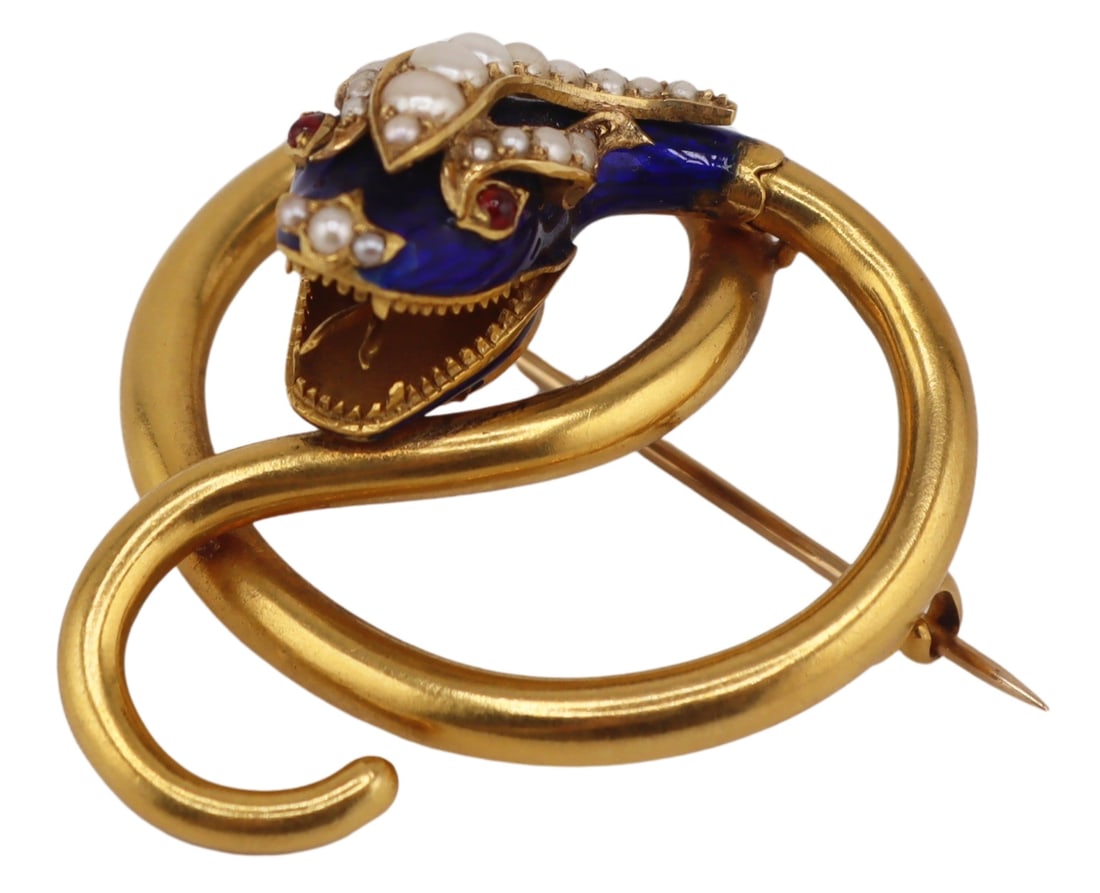 JEWELRY. Victorian Gold, Enamel, Pearl and Gem: Snake Brooch. Victorian gold coiled snake form brooch displaying blue enamel decoration to the head, (3) graduated bands of pearls, a pair of round garnet cabochon eyes, and a trio of seed pearls to t