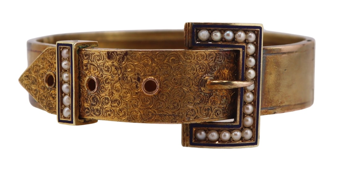 JEWELRY. Victorian Gold Enamel and Seed Pearl: Buckle Form Bracelet. Victorian gold hinged jarretiere or buckle form bracelet displaying a chased scroll motif, and seed pearl panels surrounded by blue enamel or taille d'epargne. Apparently unmarke