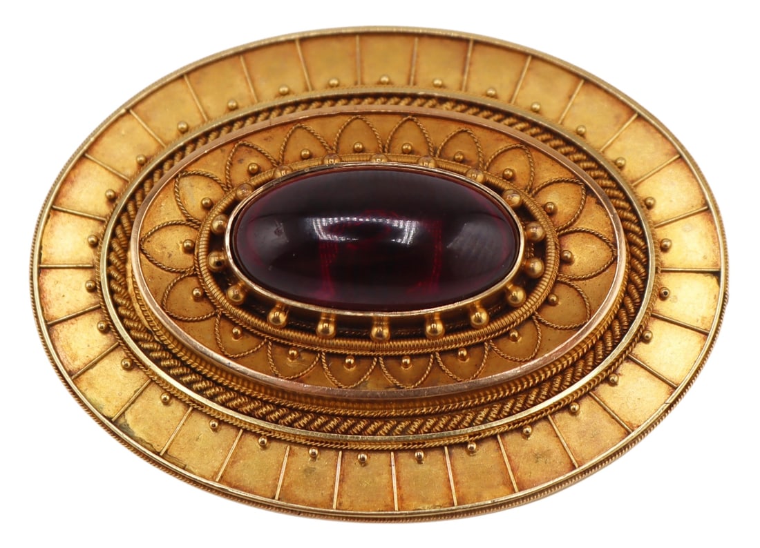 JEWELRY. 19th C Signed 18ct Gold and Garnet: Brooch. Victorian Signed E.B English 18ct yellow gold oval form brooch with millibeading and linework surrounding a central bezel set oval garnet cabochon. Birmingham, E.B, and a date letter of 1889. 