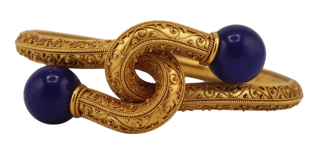 JEWELRY. Etruscan Revival Gold and Lapis Bracelet.: Etruscan Revival 15ct yellow gold hinged bypass style interlocking bracelet accented by millibeading and ball form Lapis Lazulis terminals. Apparently unmarked. Totalk approx. weight of the bracelet i