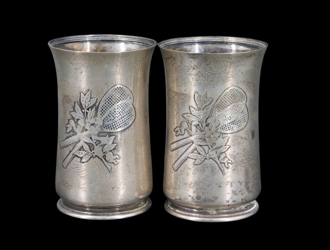STERLING. Tiffany & Co. Sterling Tennis Beakers.: A pair of Tiffany & Co. sterling silver presentation beakers executed under the directorship of Edward Moore (1873-1891), each with crossed tennis rackets and the inscription, "Rochester Lawn