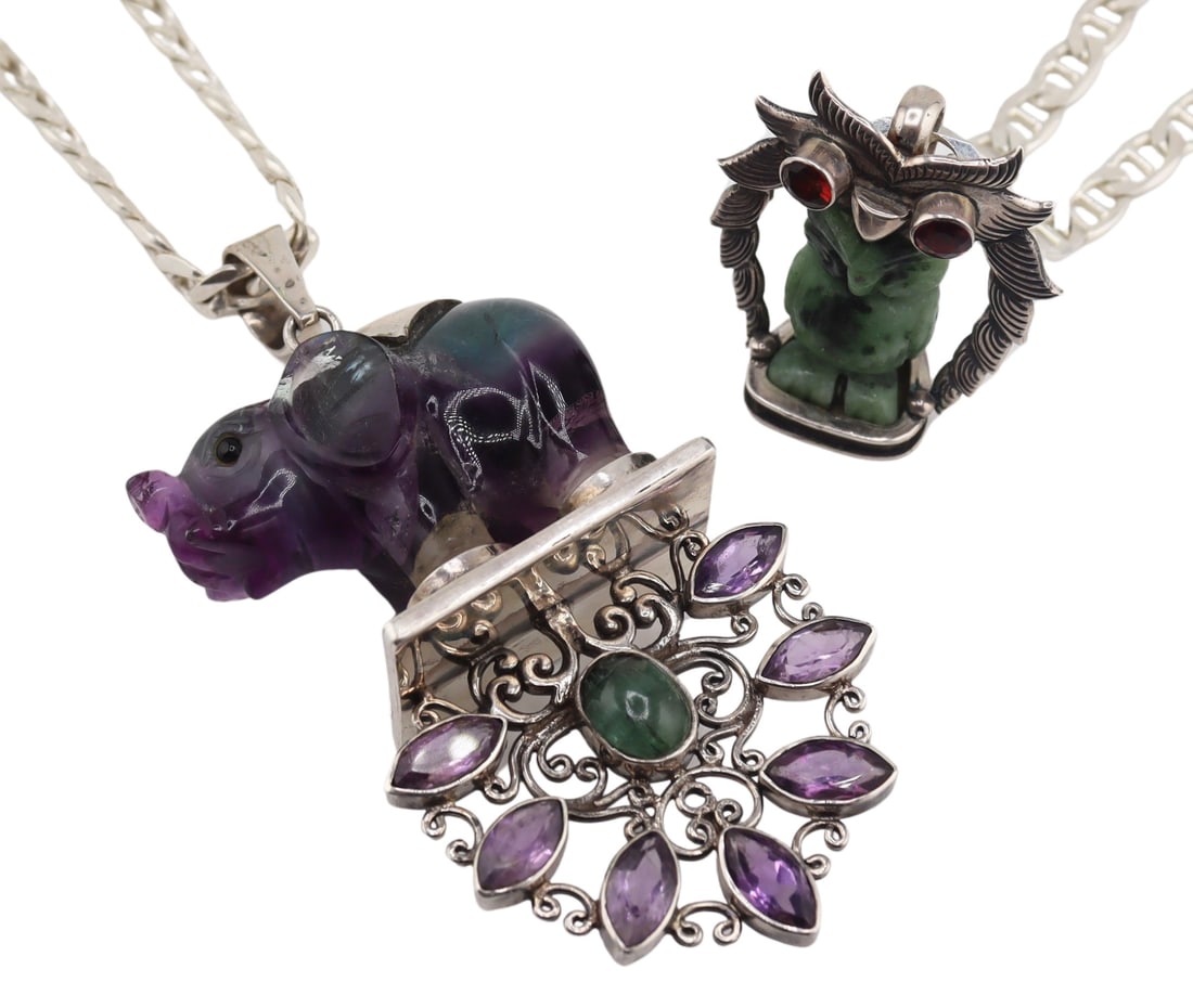 JEWELRY. 2 Carved Animal Pendants on Chain.: Includes a large sterling mounted carved bi-color gem carving an elephant set atop a rectangular base with scroll form floral pendant accented by (7) bezel set marquis faceted amethysts and a central 