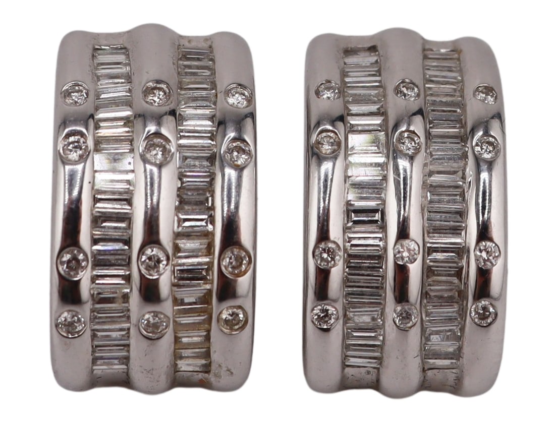 JEWELRY. Pair of Signed 18kt Gold and Diamond: Half Hoop Earrings. Pair of signed 18kt white gold half hoop earrings displaying alternating band of flush set pave diamonds, and diamond baguettes. Stamped, "18K 750" with an illegible make