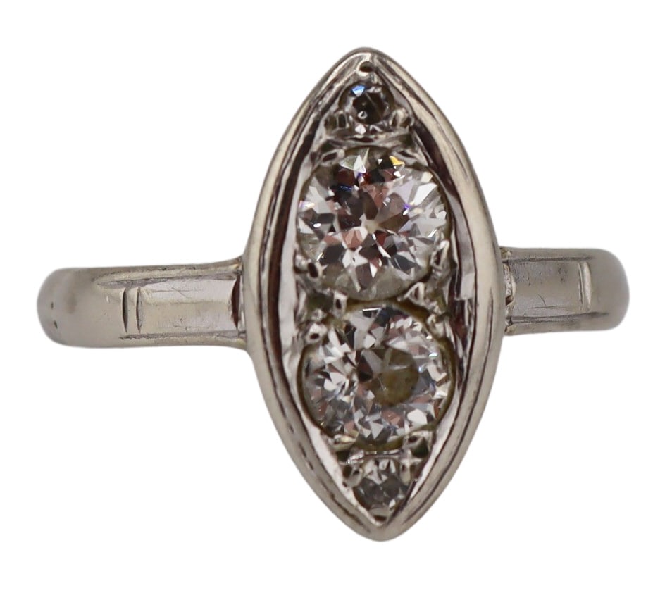 JEWELRY. 12kt Gold and Diamond Navette Ring.: 12kt white gold ring displaying a navette form pendant inlaid with (2) Old European cut diamonds and (2) pave diamonds. (2) RBC diamonds measure approx. 3.5mm each. Stamped, "14K". Total app
