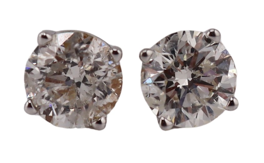 JEWELRY. Pair of 0.65ct Diamond Stud Earrings.: Pair of 14kt white gold prong-set stud earrings displaying round brilliant cut diamonds weighing between 0.65cts and 0.70cts each. One diamond measures approx. 5.6mm and one diamond measures approx. 5