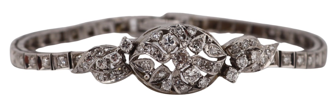 JEWELRY. 14kt Gold and Diamond Bracelet.: 14kt white gold bracelet displaying a central oval form pendant accented by full and single cut diamond accents and a pave diamond inlaid bracelet. Stamped, "14K" to the foldover clasp. Tota