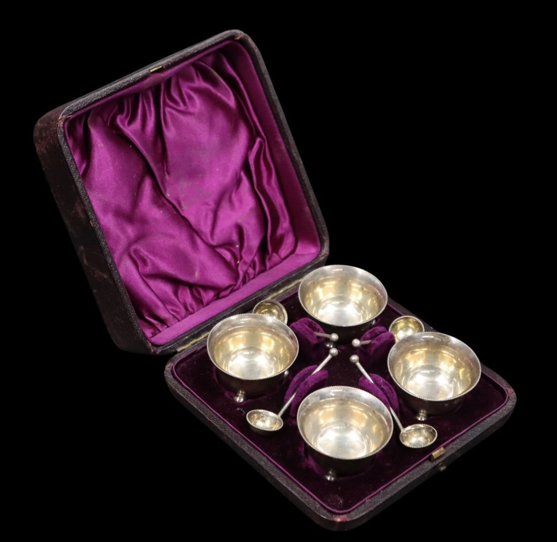 SILVER. Cased Victorian English Silver Salt Cellar: Set. A cased English silver salt cellar set comprised of (4) cellars and (4) spoons. Each bearing a city mark of London, maker's mark of Horace Woodward & Co. and a date letter of 1885. Total appr