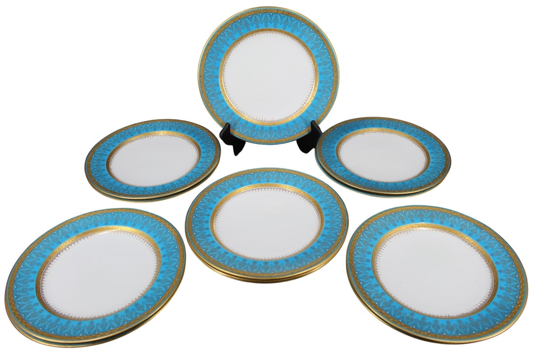 12 Wedgwood Jeweled Service Plates: A set of 12 Wedgwood jeweled service plates, with turquoise and gilt border. Signed "Gilman & Collamore / 5th Ave & 30th Street/ New York". One plate with a red iron Wedgwood mark, one plate with a bl