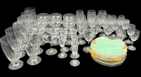 GROUPING of BACCARAT Glasses & Plates.: To include: 10 Glasses (6"); 6 Champagne (4.75"); 2 Champagne (4.50"); 7 Cordial (4.75"); 5 Glasses (4.75"); 8 Glasses (6.25"); and 12 Plates (7.50" d) Stamping Baccarat. From a Sleepy Hollow NY estat