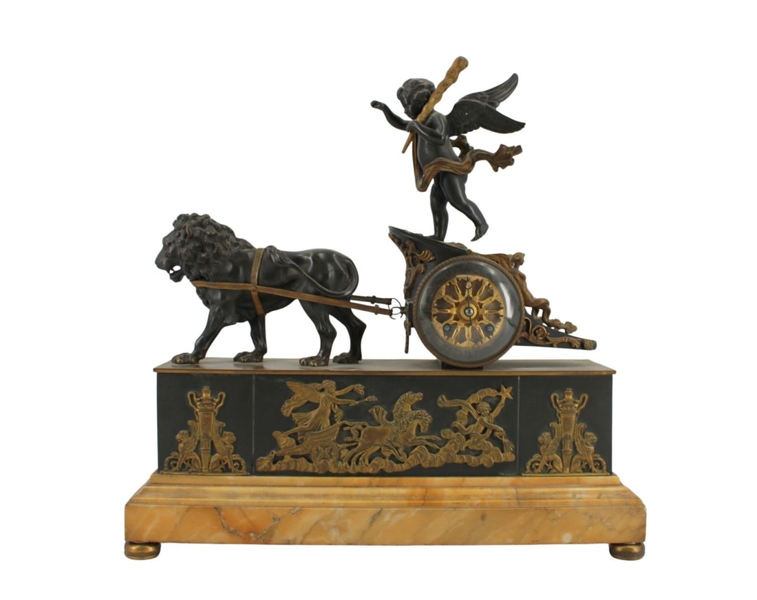 19th Century French Figural Clock: Cherub riding a chariot and being pulled by a Lion whilst raised on a marble base. The movement marked with initials. From a Yonkers NY estate. - Dimensions: 17" x 7.5"