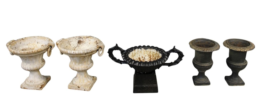 Lot Of Assorted Antique Cast Iron Urns: To include a fluted white painted pair, a black pair and a single black on pedestal. From an Ossining, NY estate. Dimensions: White Pair: 19" x 20", Black Pair: 17" x 12". Single: 29" x 10"