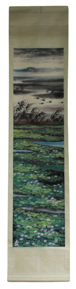 Lin Fengmian (Chinese, 1900-1991) Landscape Scroll: Painting. Tall scroll painting depicting a lake on a cloudy day with lily pads and a flock of flying birds. Longevity symbols & flowers printed throughout side board. Signed lower left. Accompanied by