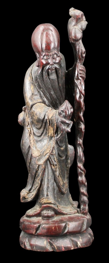 Antique Chinese Carved Wood Standing Shou Lao.: Antique Chinese wood carving of a standing Shou Lao with staff. Carved from a singular piece of dark wood. From a Mamaroneck, NY estate. Dimensions: approx. 24.5" h x 8.25" w x 7.5" d.