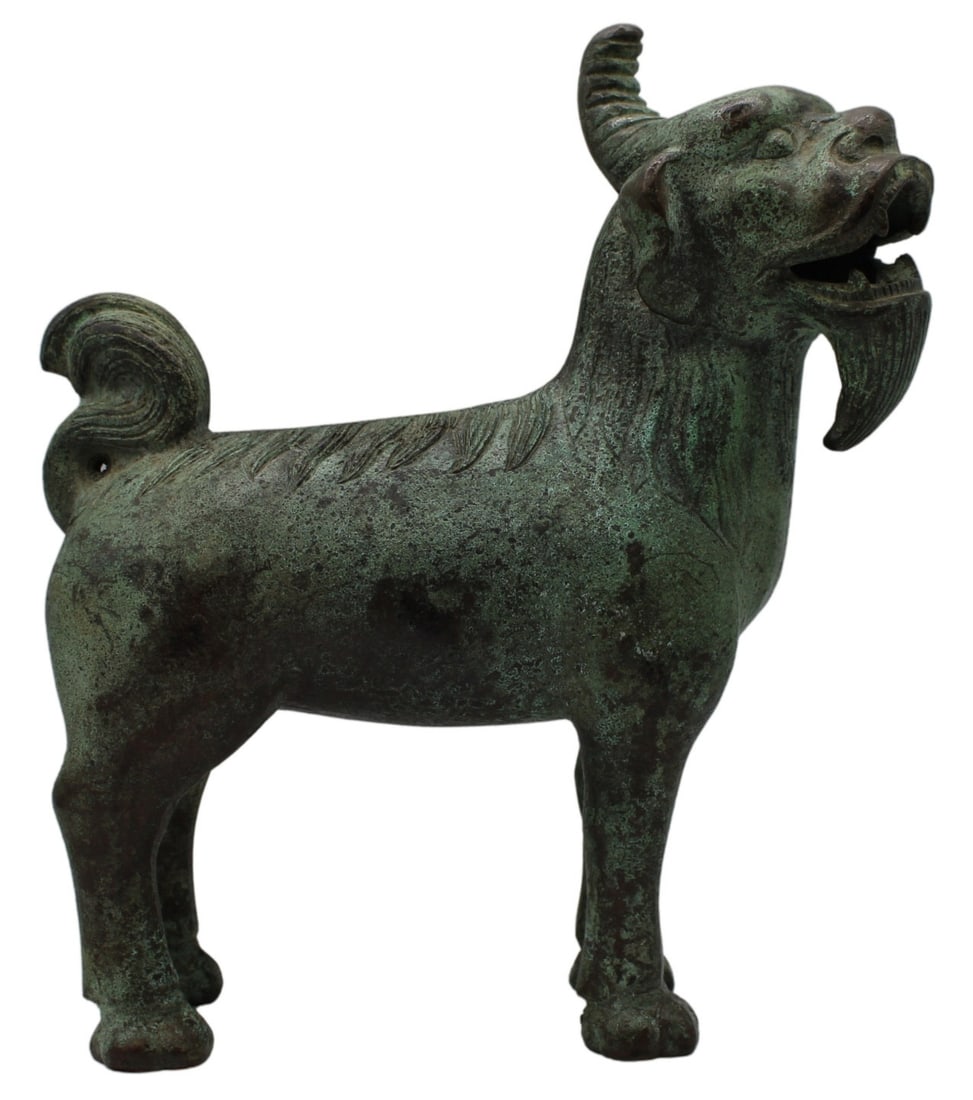 Chinese Patinated Bronze Figure of Mythical Beast: Chinese patinated bronze figure of a standing mythical beast. Total approx. weight of the piece is 4414.7 grams (gross). From a Roslyn, NY estate. Dimensions: approx. 9.75" h x 3.5" w x 9" d.