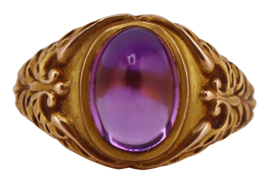 JEWELRY. Signed Amethyst Cabochon Ring.: Signed gold cocktail ring displaying a central sugarloaf amethyst accented by applied birds with outstretched wings to each shoulder. Stamped to the interior of the band with an unidentified pictorial
