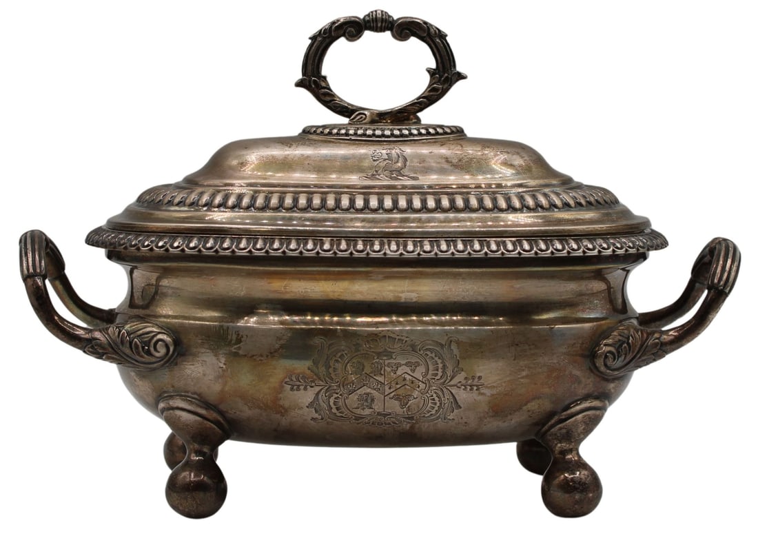 SILVER. George III Thomas Robins Lidded Tureen.: George III Thomas Robins lidded sauce tureen with ball form feet, a scroll form circular openwork handle and an ovolo border to both the lid and body of vessel. With an armorial crest to two sides of 