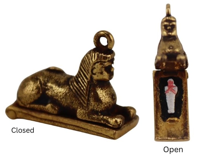JEWELRY. Payton, Pepper & Sons Ltd 9ct Gold Sphynx: with Mummy Charm. Payton, Pepper & Sons Ltd. English 9ct yellow gold hinged sphinx form charm opening to reveal an enamel decorated mummy. Stamepd to the underside, "PPLd 9 .375" with Birmingham stamp