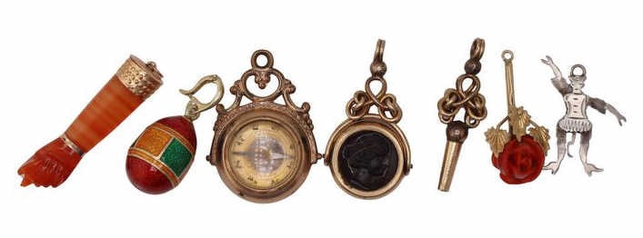 JEWELRY. Assorted Gold, Silver, and Costume Charms: Including an unmarked Victorian gold-tone compass charm; an unmarked Victorian gold-tone intaglio charm; an unmarked Victorian gold-tone watch key charm; a gilt sterling and guilloche Faberge style eg