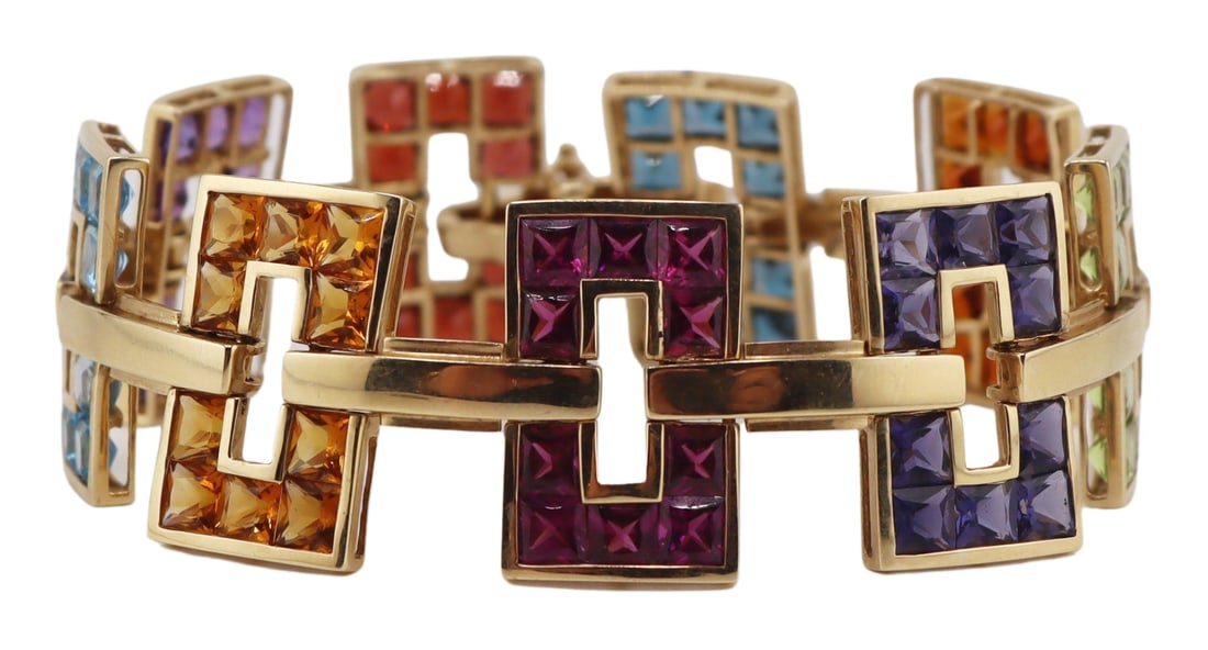 JEWELRY. Signed 14kt Gold and Colored Gem Bracelet: Signed 14kt yellow gold statement bracelet comprised of (9) rectangular form openwork pendants - each inlaid with French cut colored gems. Stamped, "14K ©" with an unidentified diamond form