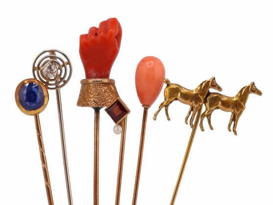 JEWELRY. (6) Assorted 10kt Gold Stickpins.: Including (1) unmarked 10kt yellow gold horse stickpin; (1) unmarked 10kt yellow gold stickpin with a polished coral bead; (1) unmarked 10kt yellow gold stickpin with a carved coral fist mounted on a 