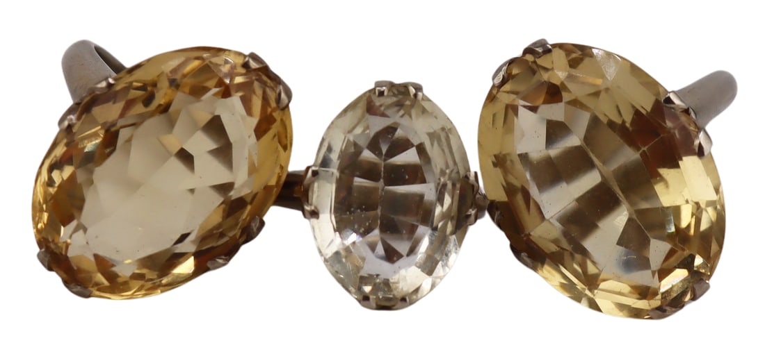 JEWELRY. (3) Large 14kt Gold & Gem Cocktail Rings.: Includes a 13kt white gold cocktail ring displaying a large central prong-set oval faceted yellow gem - stamped, "14K", gem measures approx. 21.5mm x 16.5mm; a 13kt white gold mounted cocktail ring di
