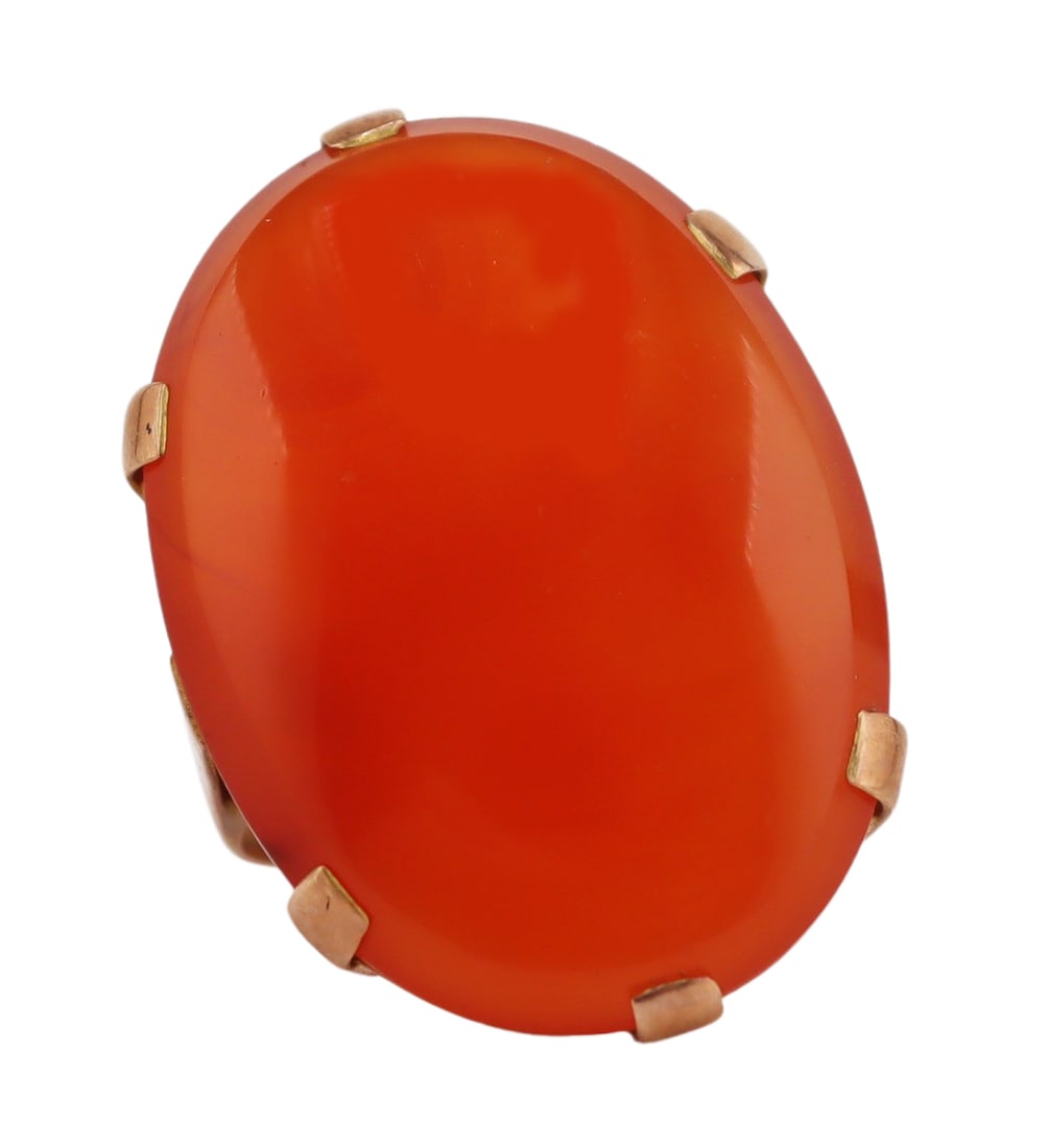 JEWELRY. Large 9kt Gold and Carnelian Ring.: Large 9kt yellow gold mounted ring displaying a prong-set oval Carnelian with beveled edge. Apparently unmarked. Total approx. weight of the ring is 6.4 dwt (gross). From a Kent, CT estate. Dimensions