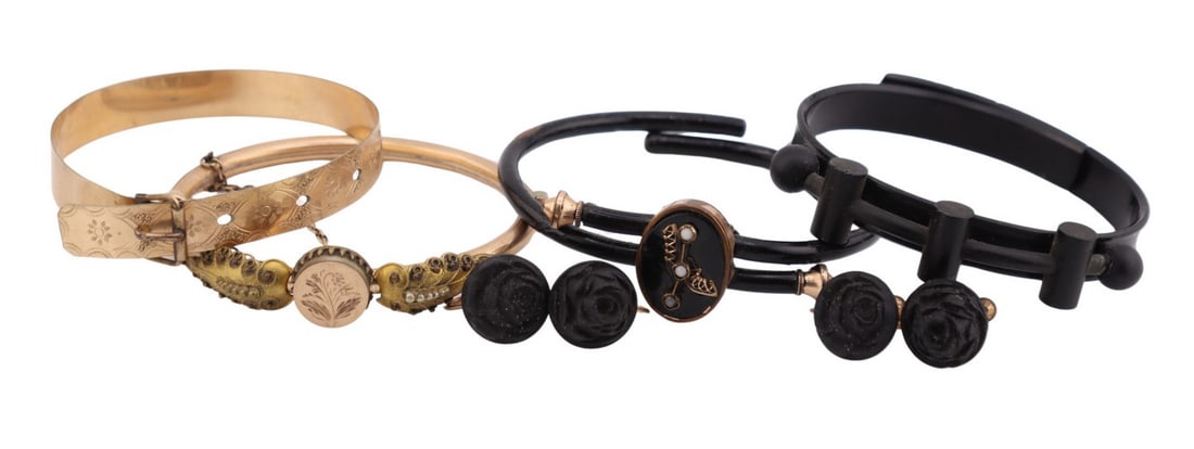 JEWELRY. Victorian Bangle & Cuff Grouping.: Including a Victorian gold-tone hinged cuff with a central chased flower flanked on both sides by applied leaves; a Victorian vulcanite bangle with applied decoration; (2) pairs of Victorian gold-tone