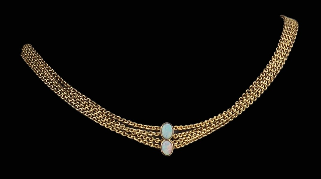 JEWELRY. Four-strand Gold and Opal Choker.: An unmarked 13kt yellow gold four-strand choker comprised of four chain link strands joined to a central applied element set with (2) bezel-set opal cabochons soldered together. The four strands are s