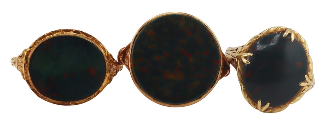 JEWELRY. (3) Gold and Bloodstone Rings.: Includes an antique 10kt yellow gold filigree ring displaying a central prong-set oval bloodstone - stamped, "10KT" with a triangular pictorial hallmark, ring size - 6, repair to the shank; a 9ct yell