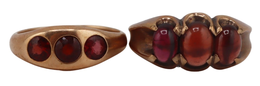 JEWELRY. (2) Antique Gold and Garnet Rings.: Includes a 14kt yellow gold gypsy ring displaying (3) round faceted garnets and a tapered band - stamped, "14K", size - 8 3/4; and a 9ct yellow gold band displaying (3) oval garnet cabochons within a 