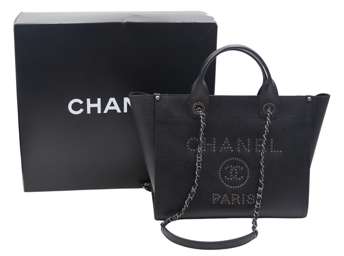COUTURE. Chanel Studded Deauville Tote Bag.: Chanel studden "CC" Deauville black caviar leather tote bag with leather woven silver-tone chain link straps with black leather shoulder guards, and flat leather handles. Interior displays (