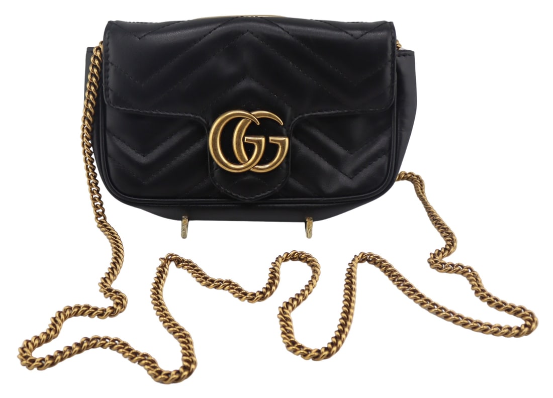 COUTURE. Gucci Black Leather Super Mini Marmont: Crossbody Bag. Gucci Double G Super Mini Marmont black leather cross body purse with gold-tone chain shoulder strap. Black leather displays a chevron pattern to the stitching and a stitched heart vers