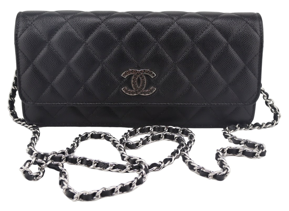 COUTURE. Chanel Quilted Black Leather Wallet on: Chain. Chanel quilted black leather foldover top wallet on woven leather and silver-tone chain shoulder strap with Double C "Coco Chanel" snap magentic closure. Interior features a central z