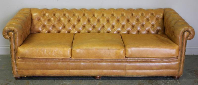 Beige Leather Chesterfield Sofa.: From a New Milford, CT location. Dimensions: 84" w x 35" d x 27" h. Condition: Good condition, free of tears, a couple of marks or scuffs to one side.