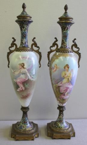 Pair of Probably Sevres Urns.: With champleve details. Each painting signed - one Bernier, and the other Delys? Stamped France underneath. From a Sleepy Hollow, NY home. Dimensions: 17" high. Condition: Good. .