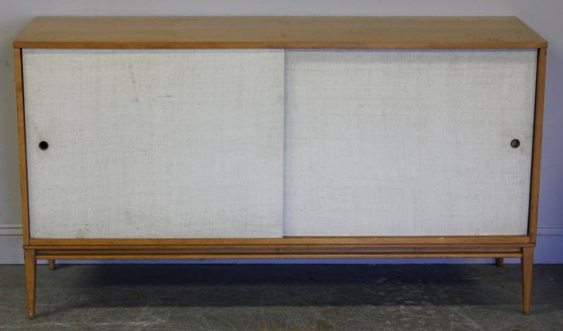 Midcentury Paul McCobb Cabinet.: With sliding grass cloth type doors. McCobb for Planner Group. From a Brooklyn, NY home. Dimensions: 60" w x 18.25" d x 33.375" h. Condition: Used condition, dirty doors.